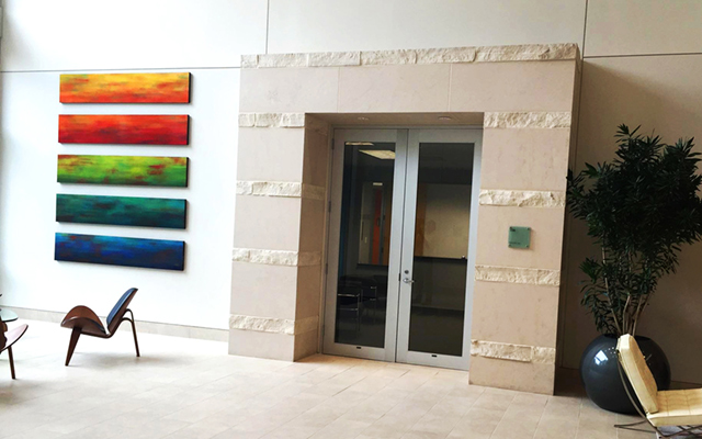 Abstract painting on wood panels, hanging in lobby